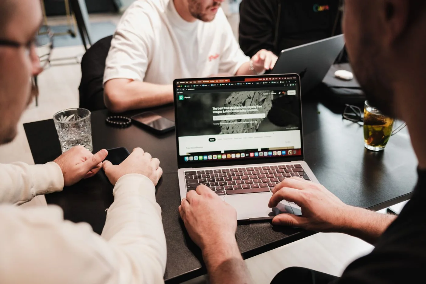 Colleagues working together around laptops.